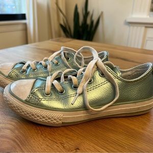 Shiny turquoise low-top Converse.